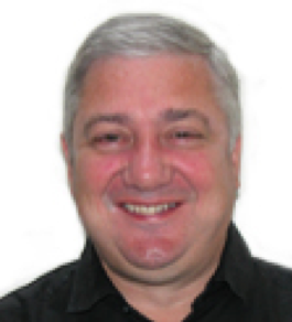 Graham Clarke, Ph.D. posing in front of white background. 
